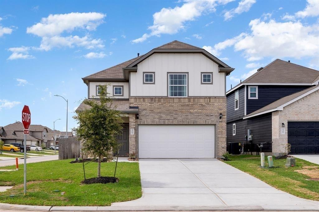 a front view of a house with a yard and garage