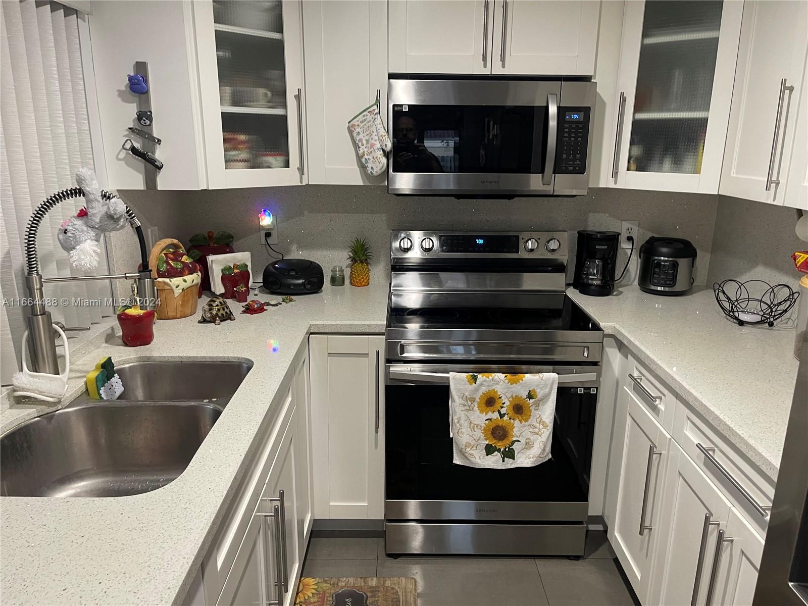 a kitchen with appliances a sink and a stove