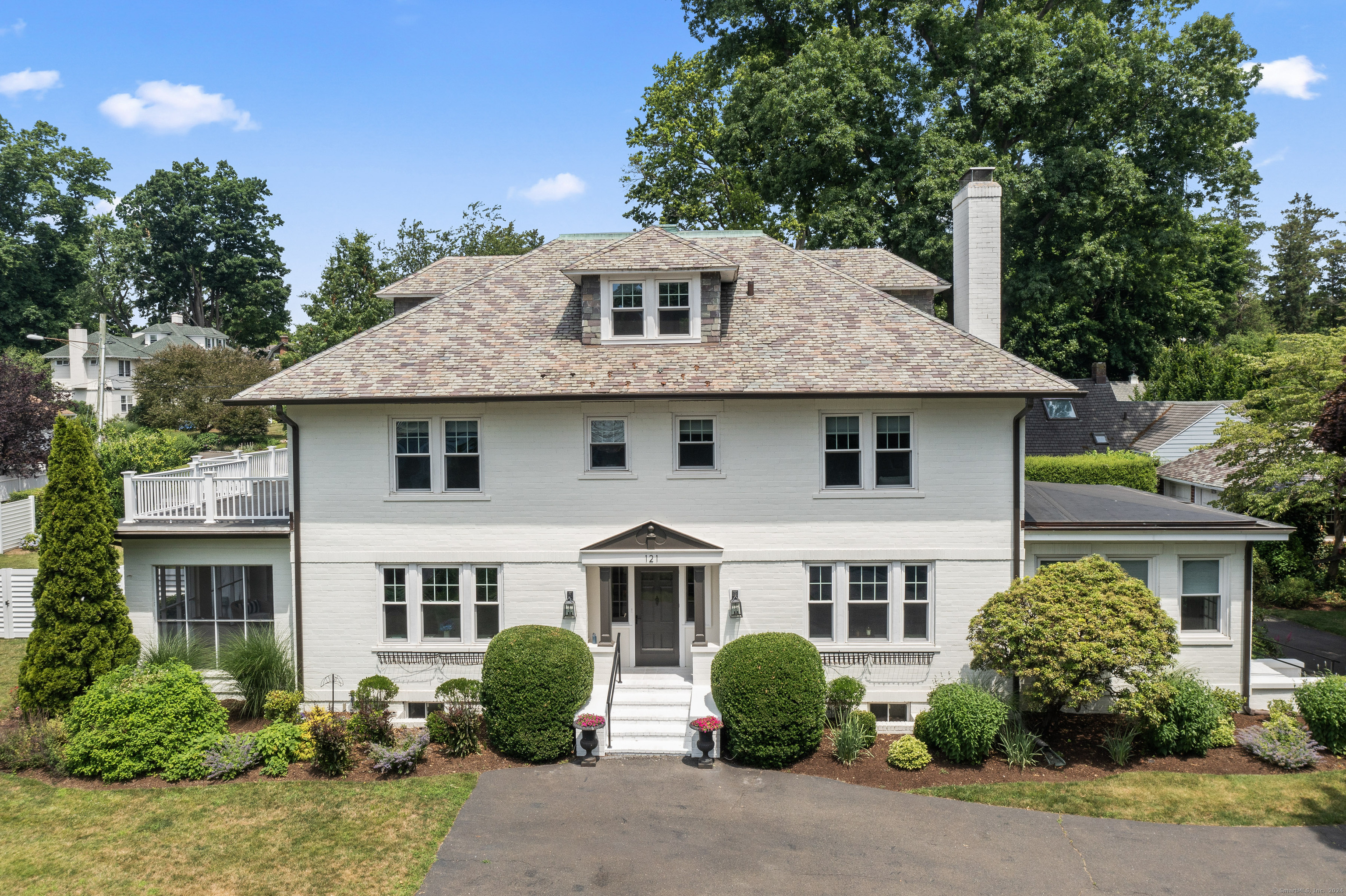 a front view of a house with a garden