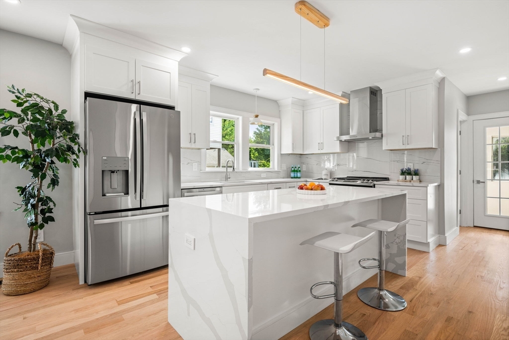 a kitchen with stainless steel appliances a refrigerator and a stove