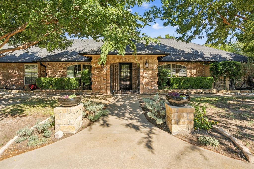 a front view of a house with a yard outdoor seating and garage