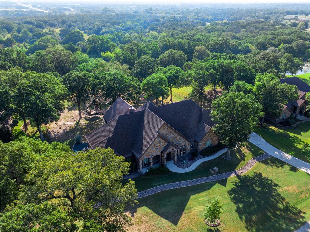 an aerial view of a house with garden space and street view