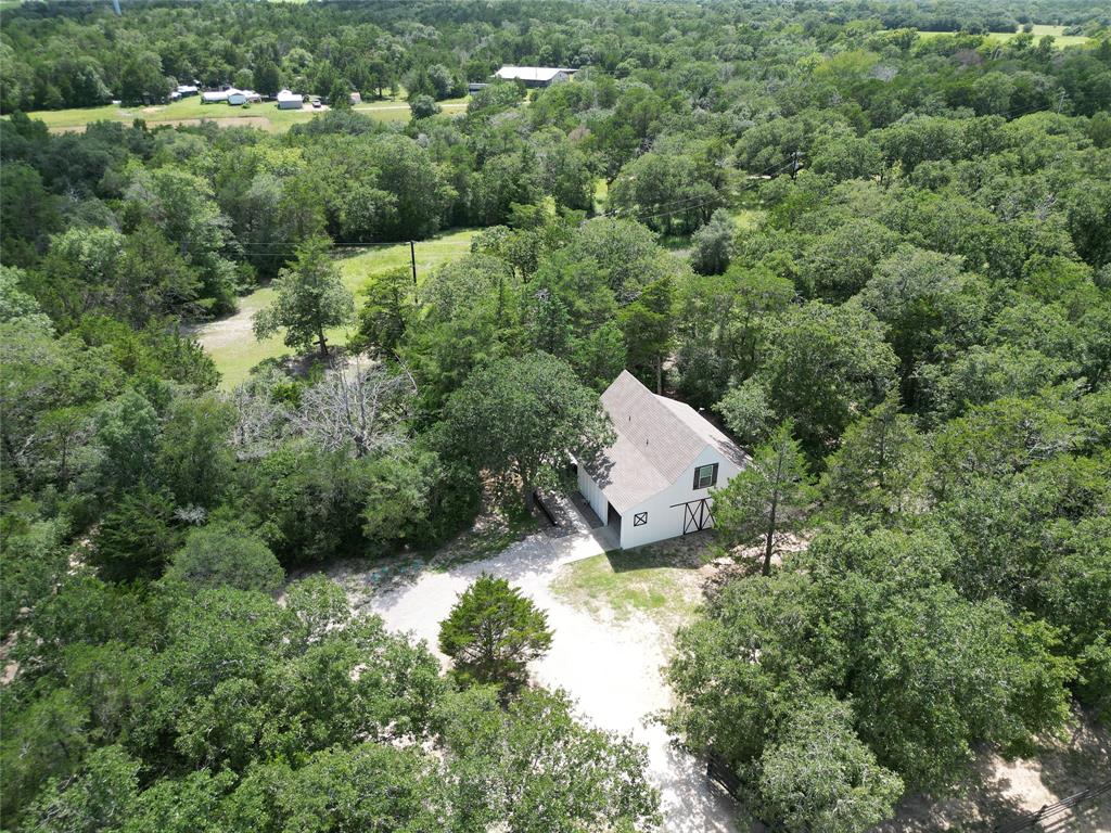 an aerial view of a house with a yard