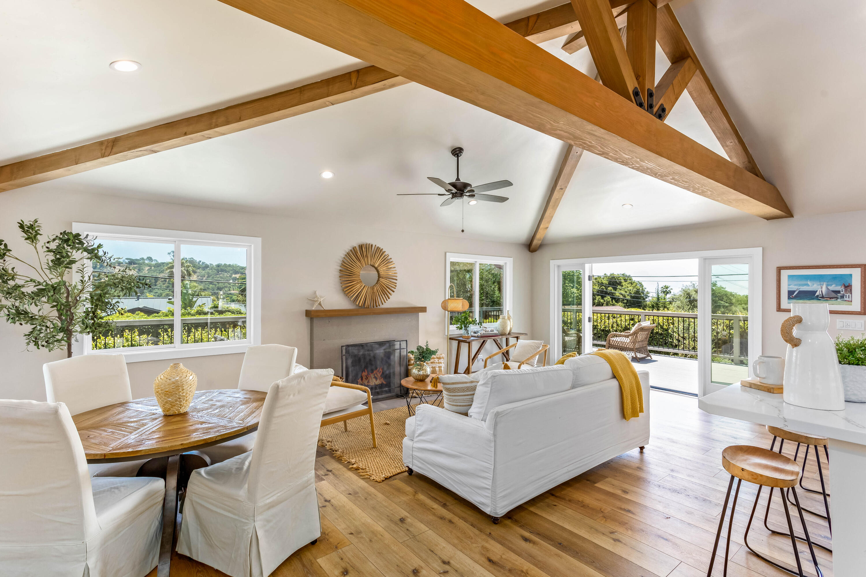 a living room with furniture a fireplace and a large window