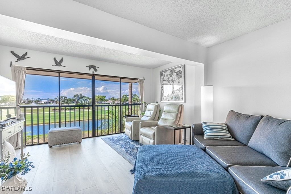 a living room with furniture and a floor to ceiling window