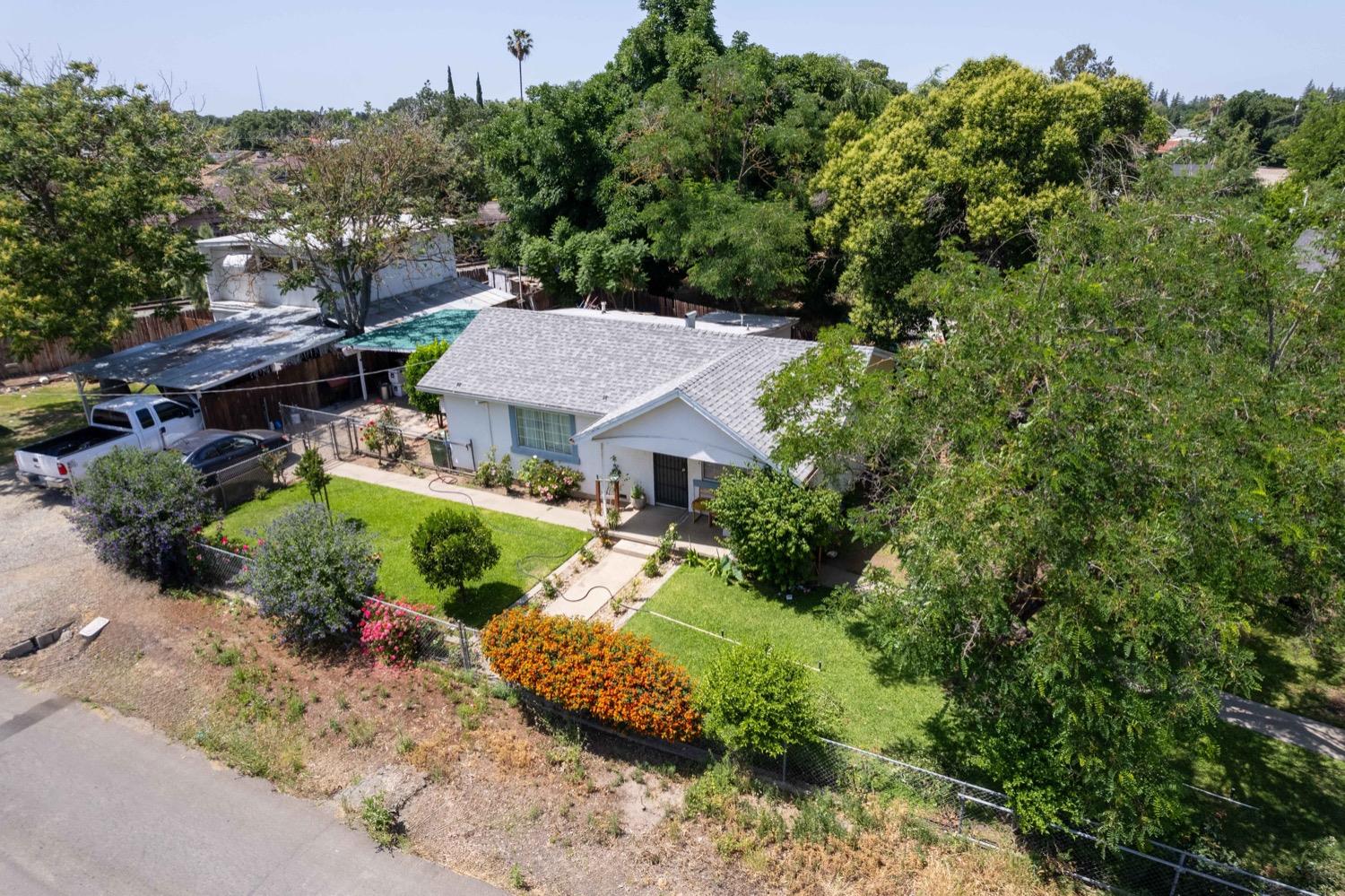 an aerial view of a house with yard and green space