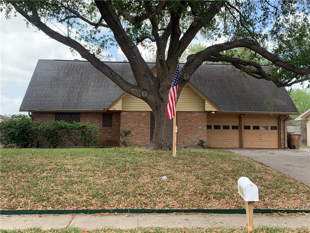 a house that has a tree in front of it