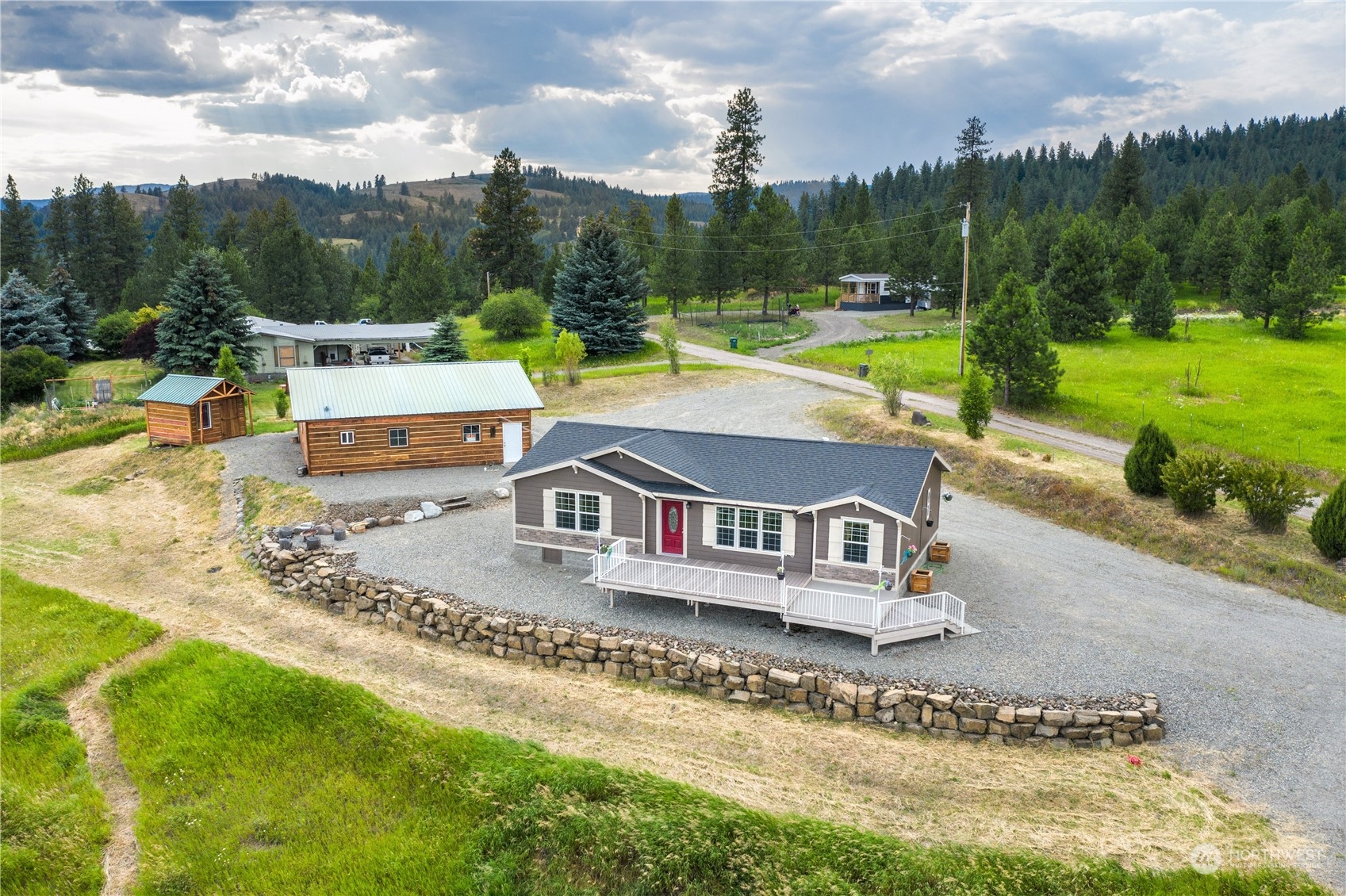 an aerial view of a house with a garden and lake view