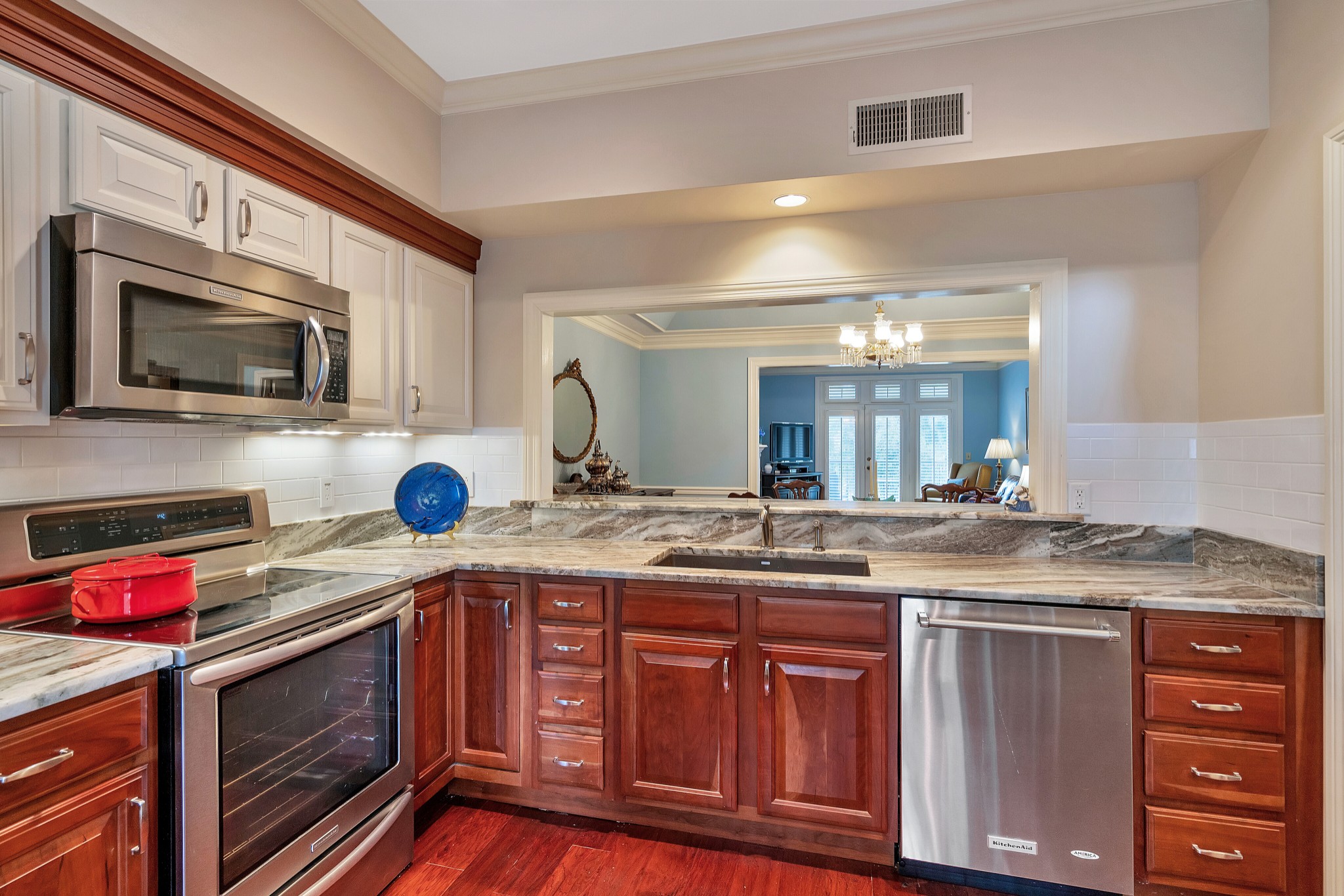 a kitchen with stainless steel appliances granite countertop a sink stove and microwave