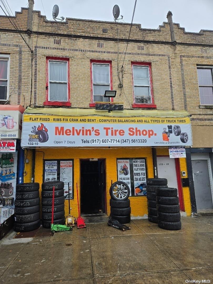 a front view of multi story building with retail shop