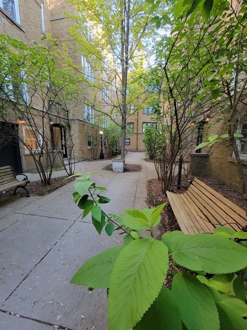 a view of a backyard with sitting area