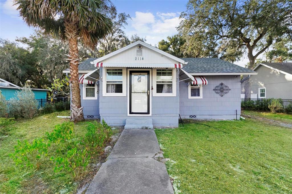 a front view of a house with a garden