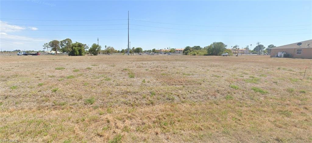 a view of a field with an ocean view