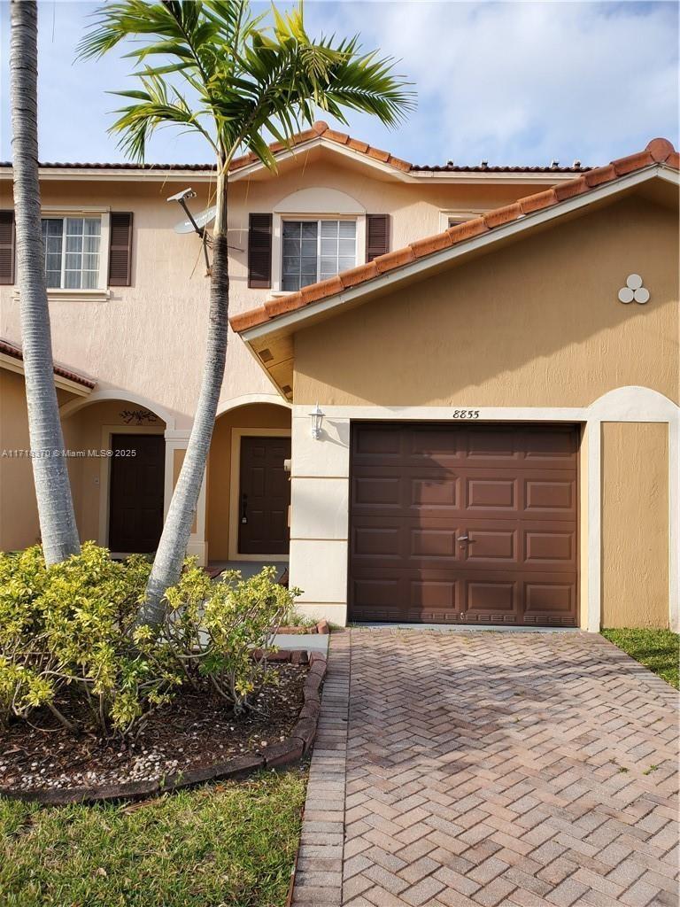 a front view of a house with a yard and garage