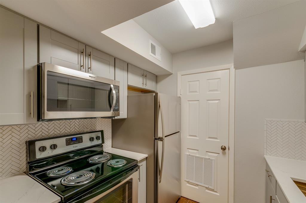 a kitchen with appliances and cabinets