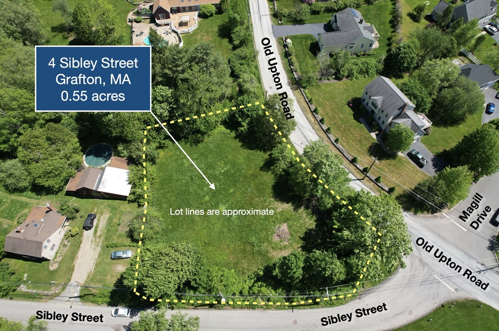 an aerial view of a house with a yard and outdoor seating