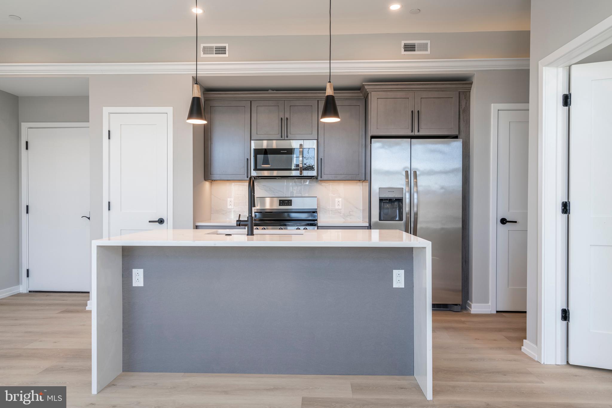 a kitchen with stainless steel appliances a refrigerator and a sink