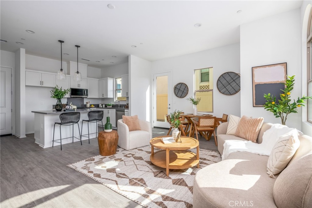 a living room with furniture and kitchen