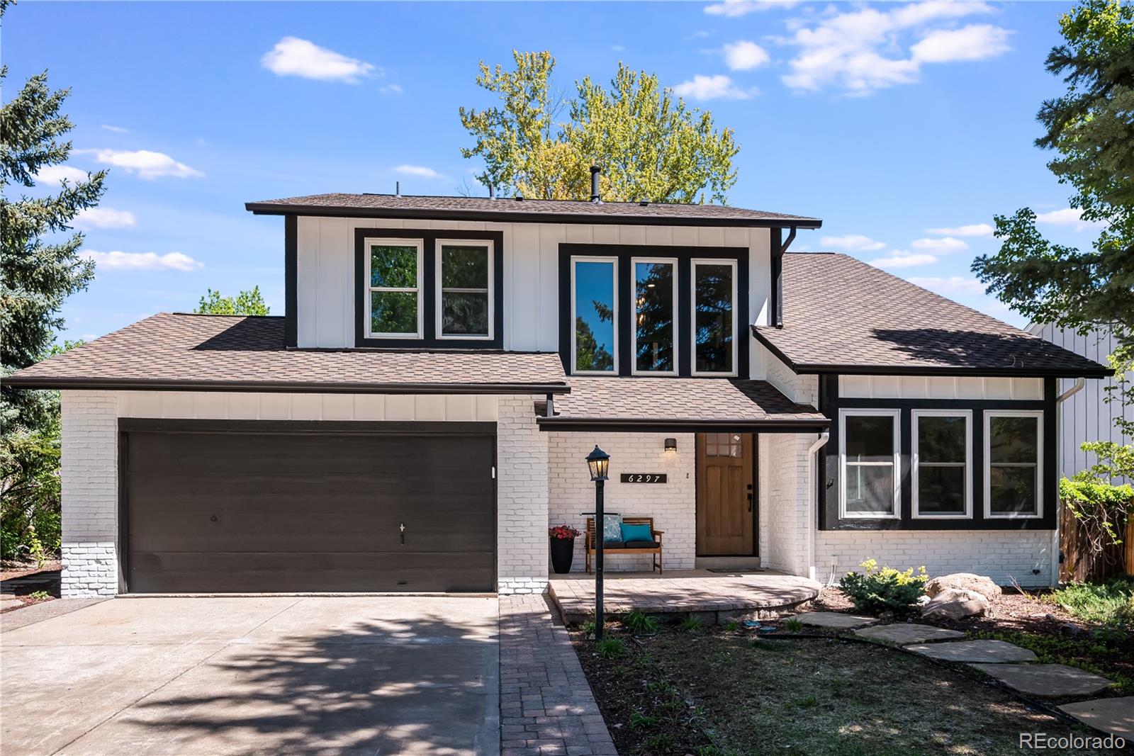 a front view of a house with a yard and outdoor seating