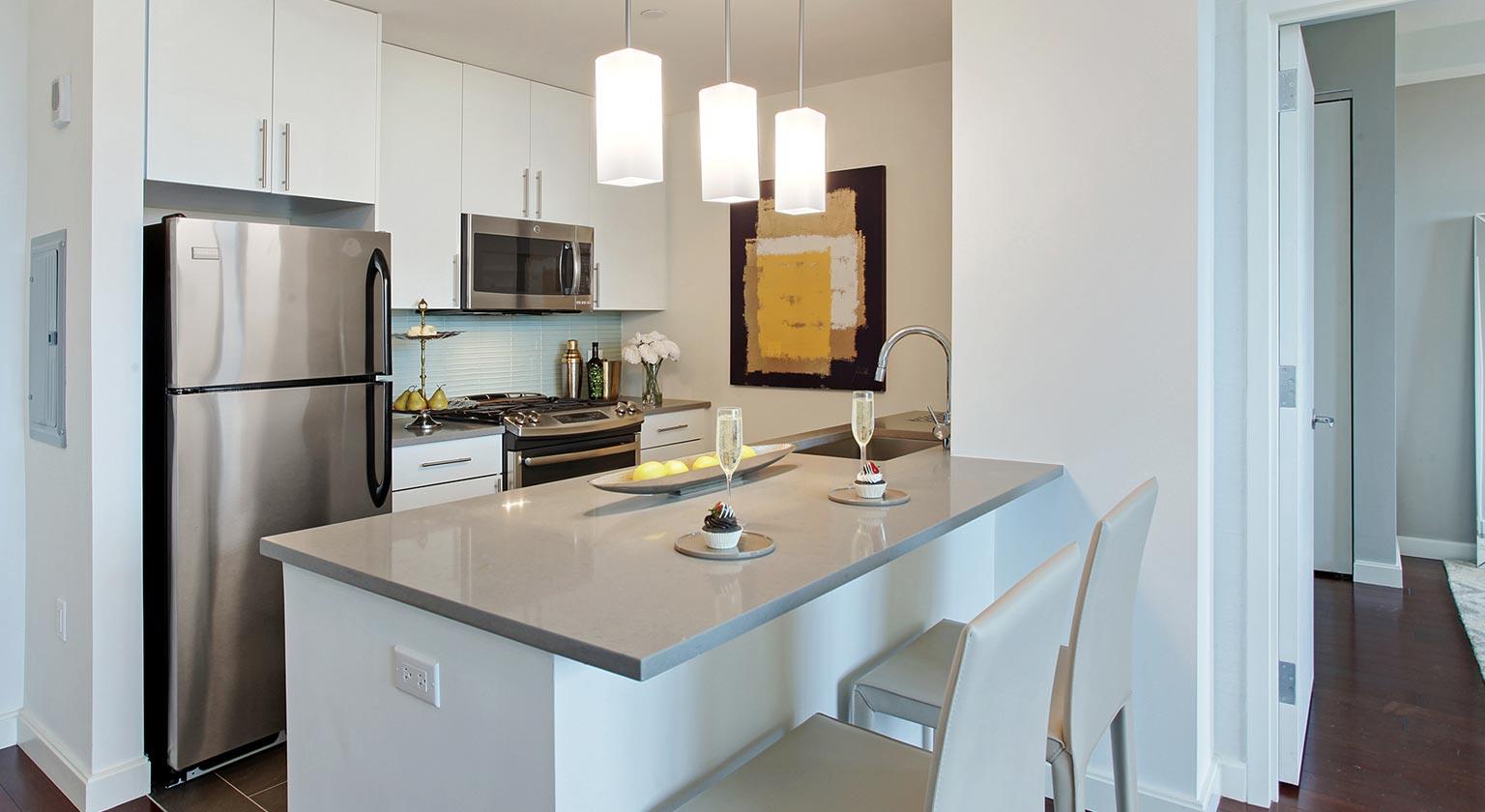 a kitchen with a sink a refrigerator and a stove