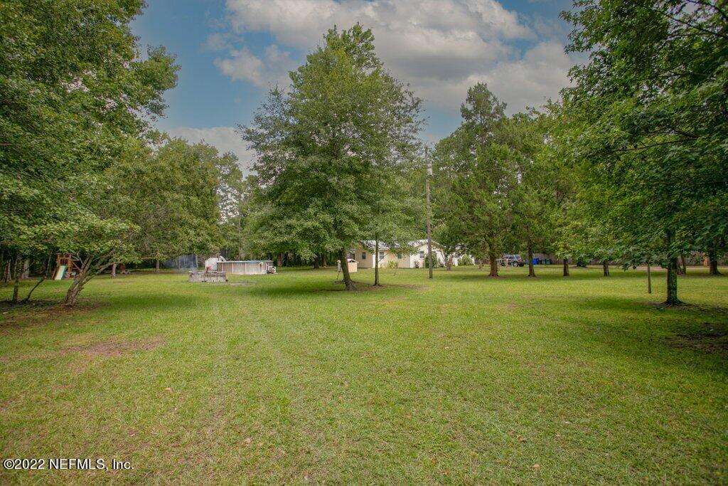 a huge green field with lots of trees