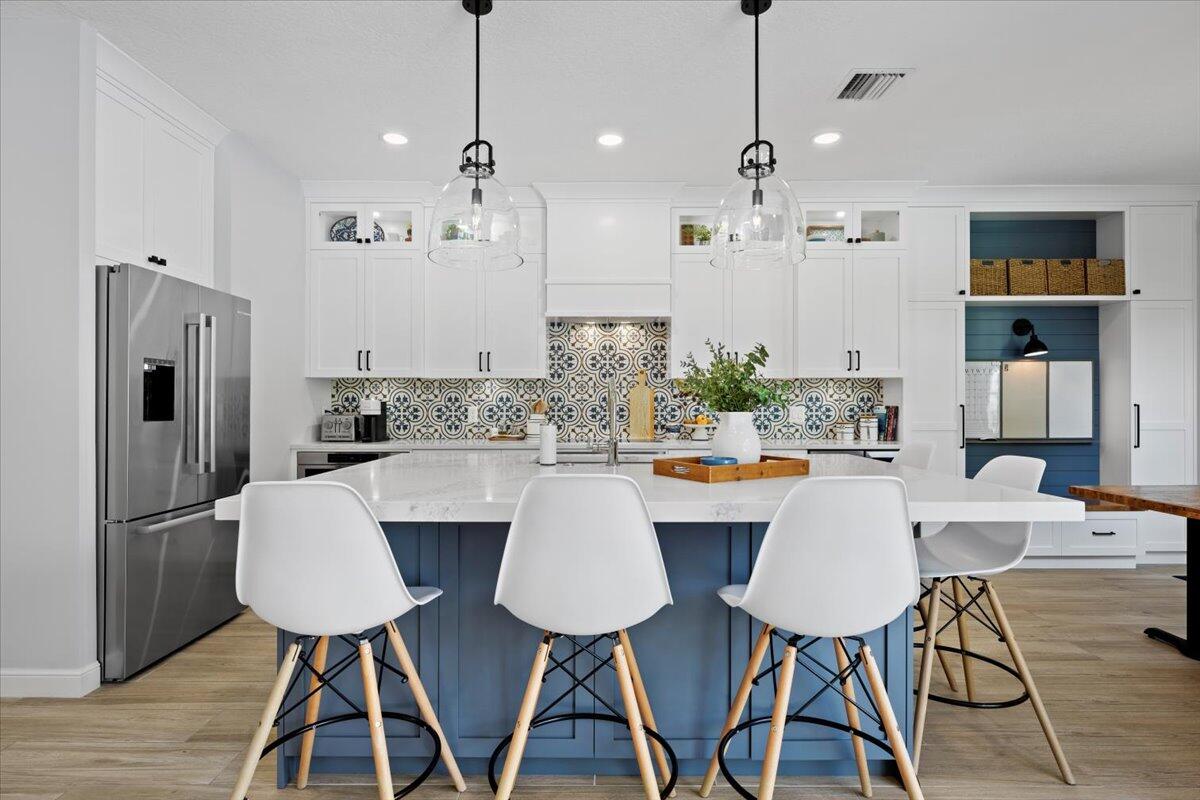 a large kitchen with a table and chairs