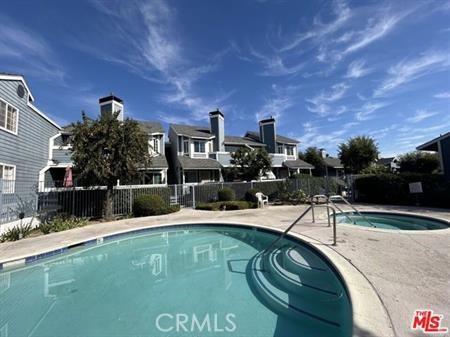 a view of a swimming pool with a patio and a yard