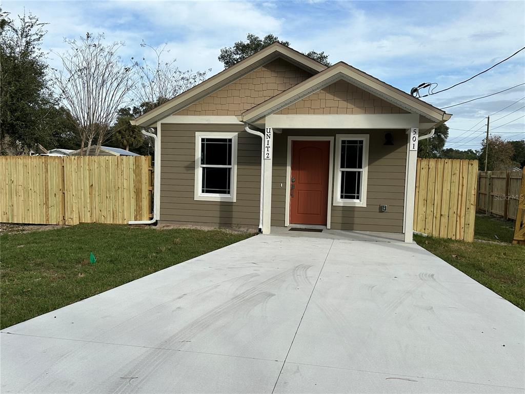 a front view of a house with a garden and yard