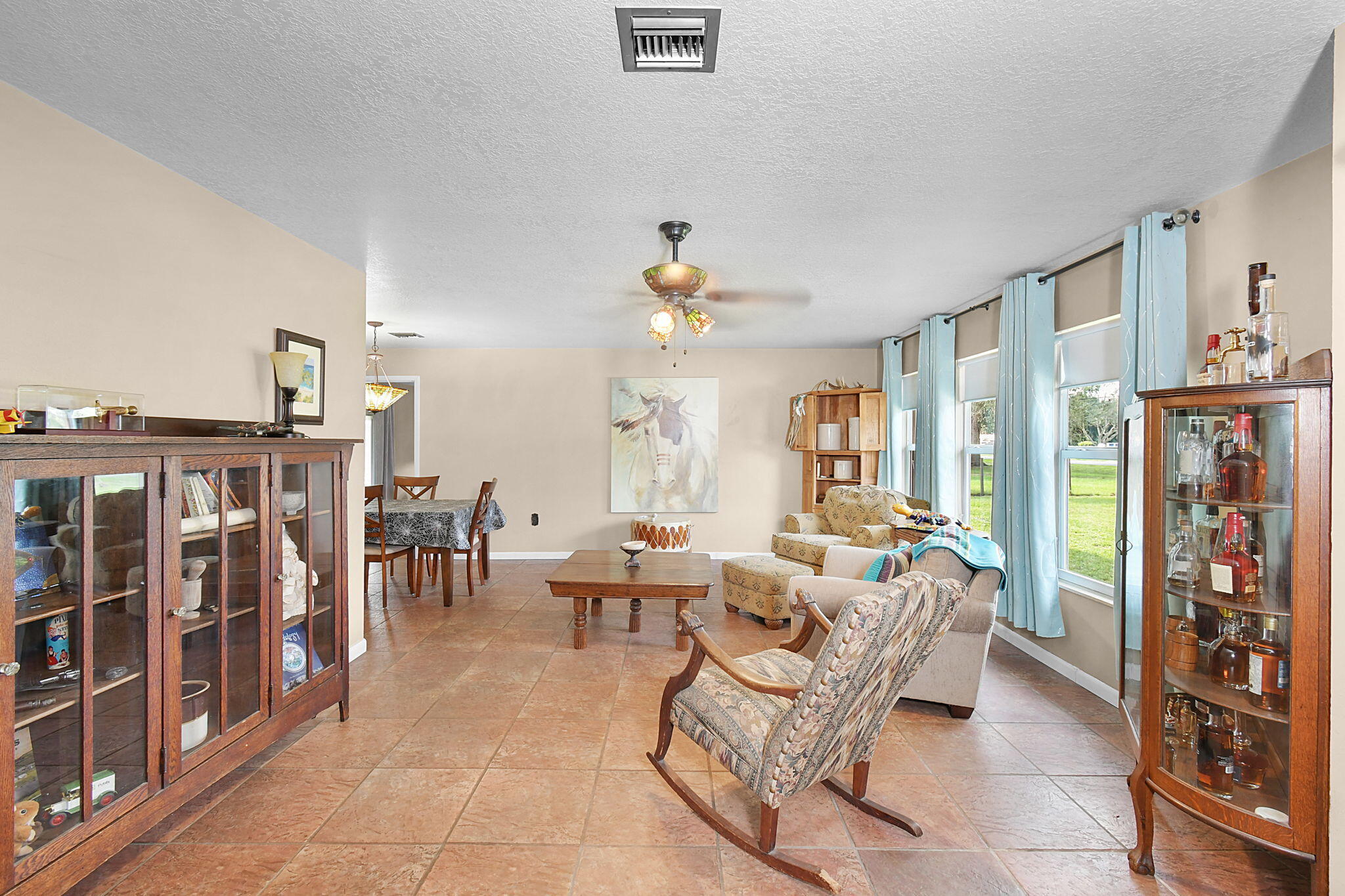 a living room with lots of furniture and a chandelier