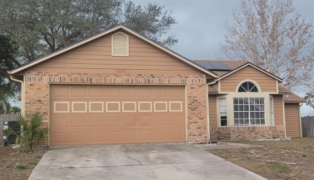 a view of a house with a yard and garage