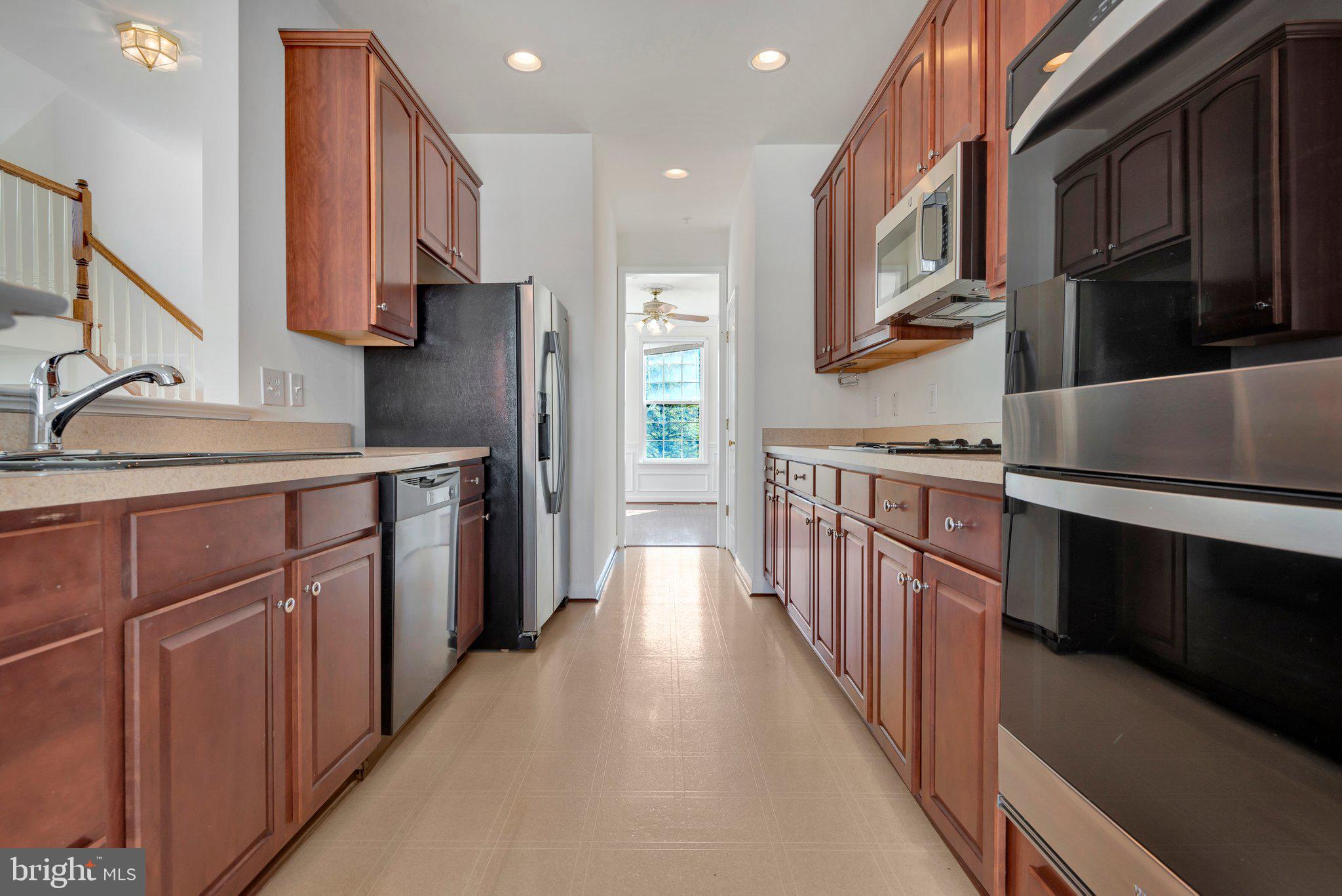 a kitchen with stainless steel appliances sink a microwave and cabinets