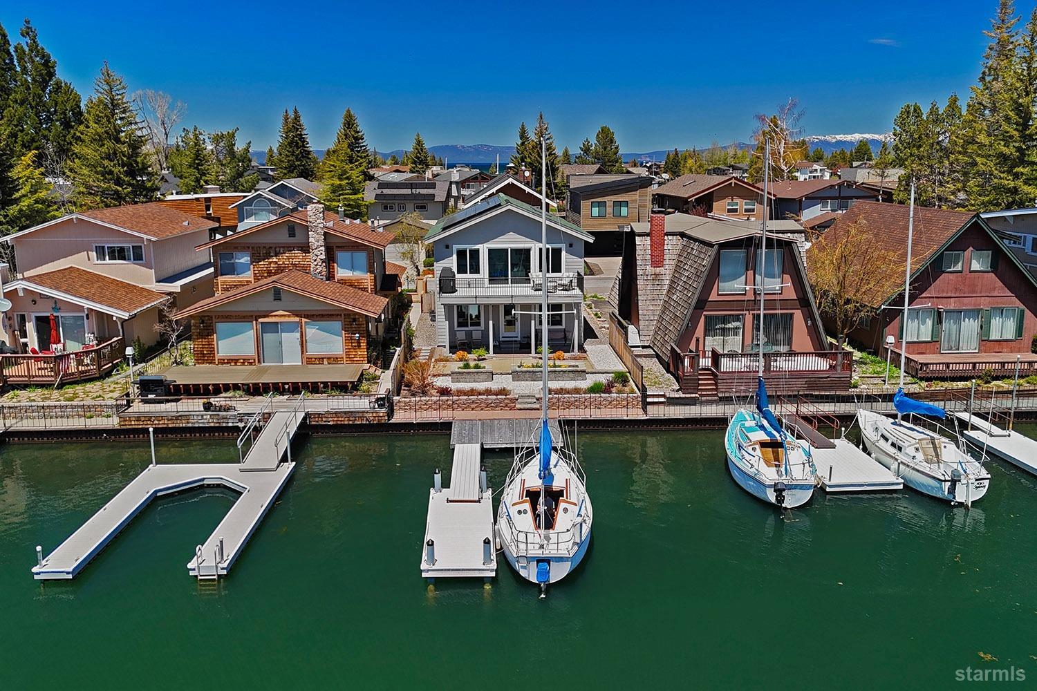 a view of a house with pool lawn chairs and a yard