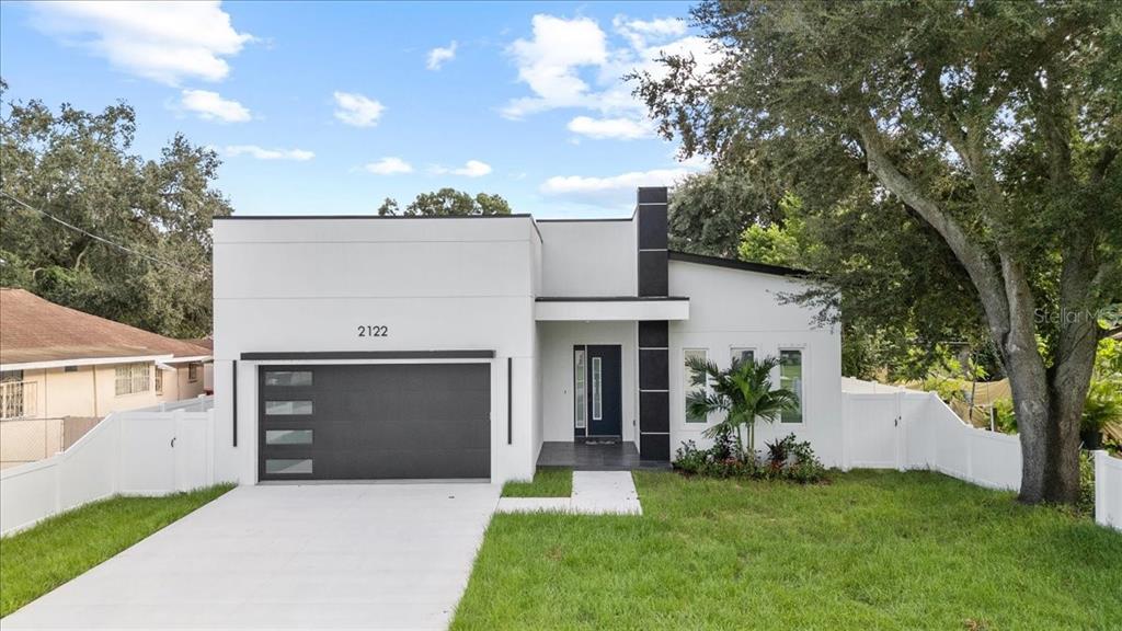 a front view of a house with a yard and a garage