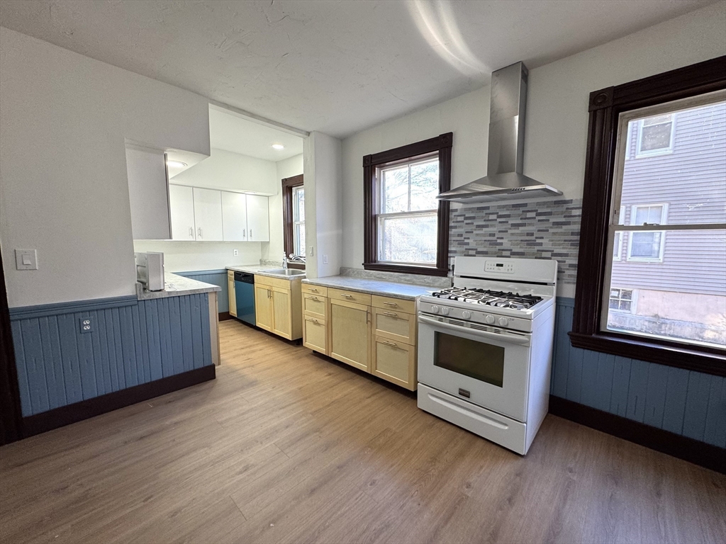 a kitchen with stainless steel appliances a stove top oven and sink