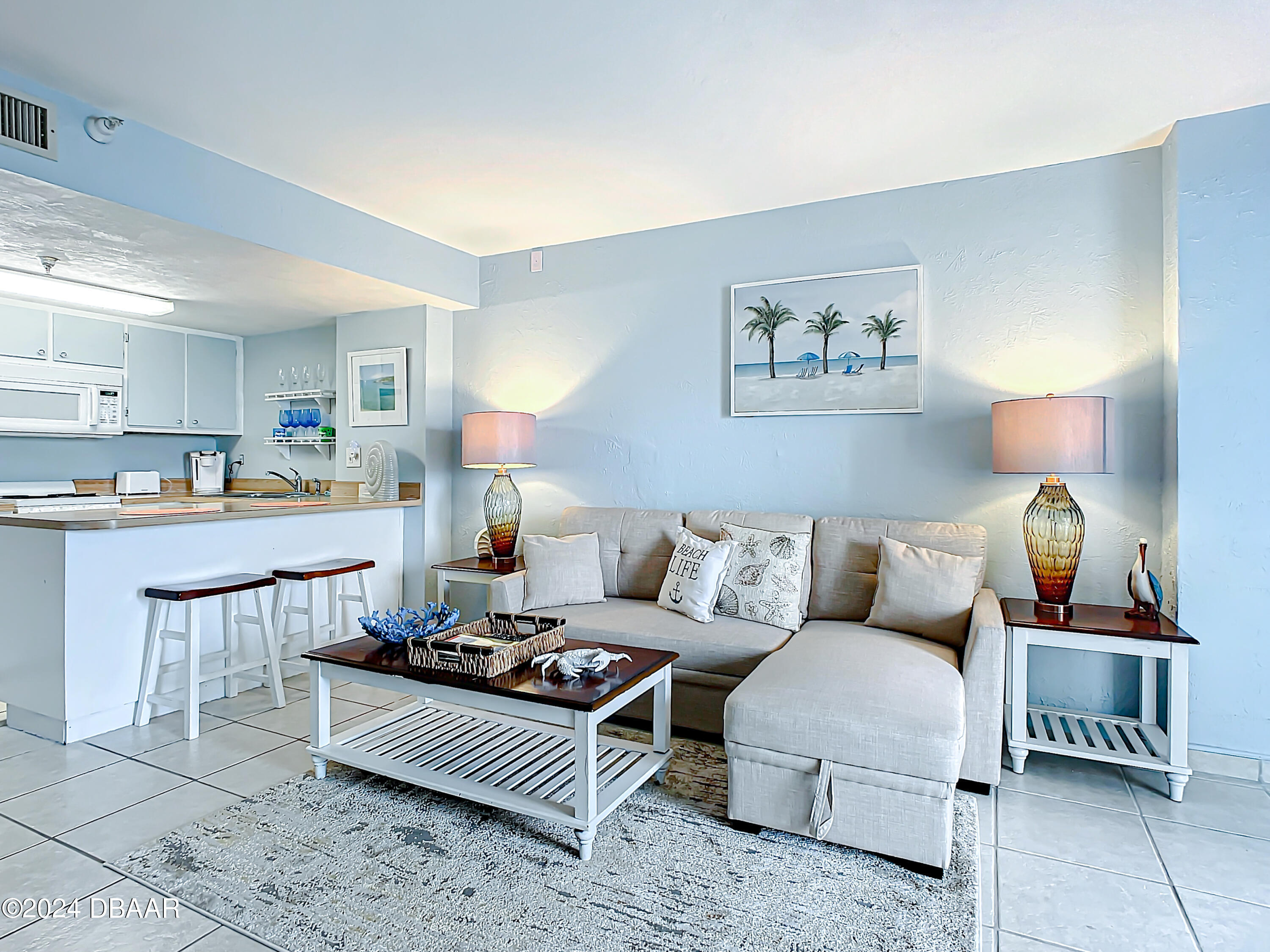 a living room with furniture and a lamp