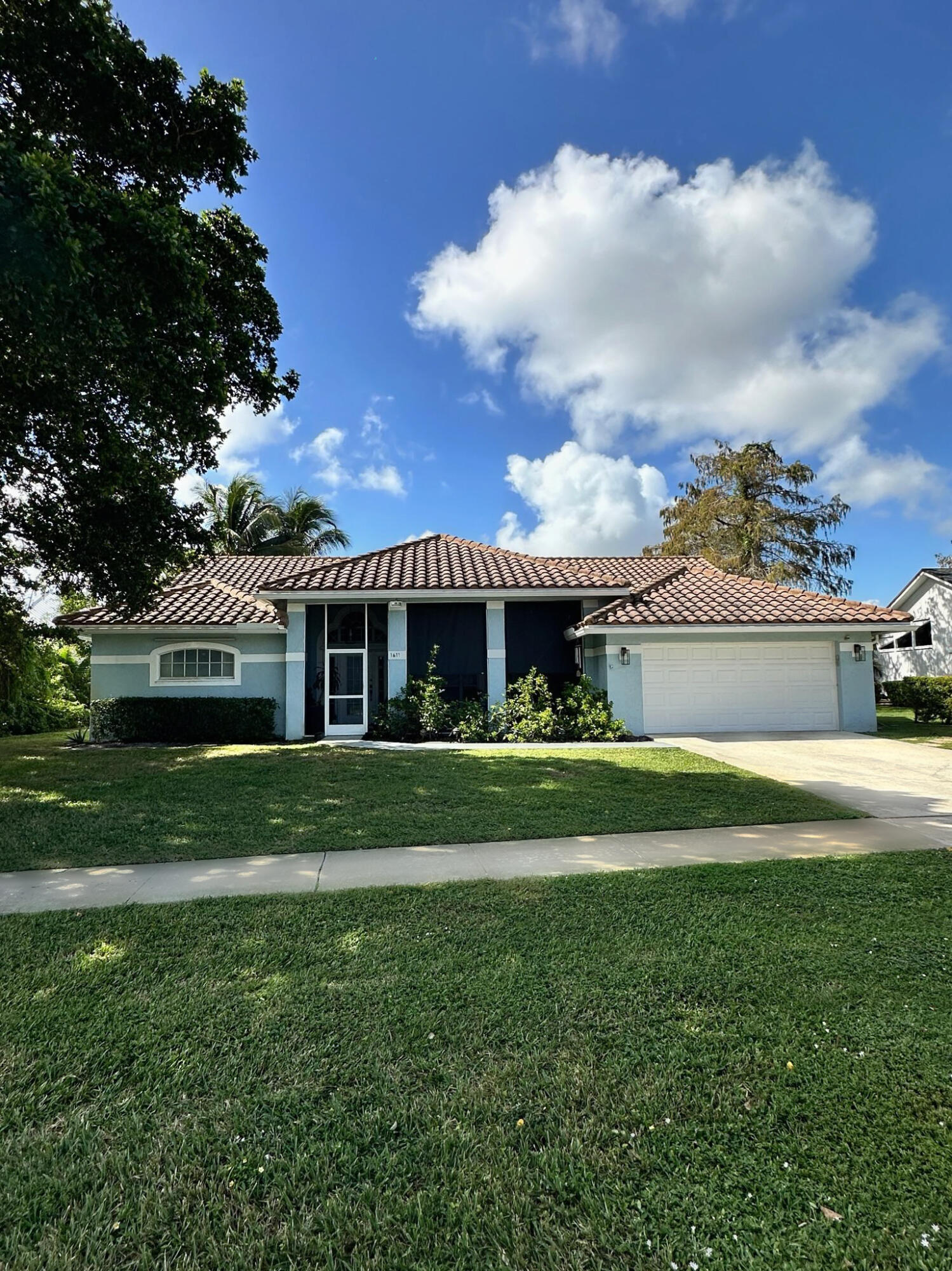 a front view of a house with a yard and front view