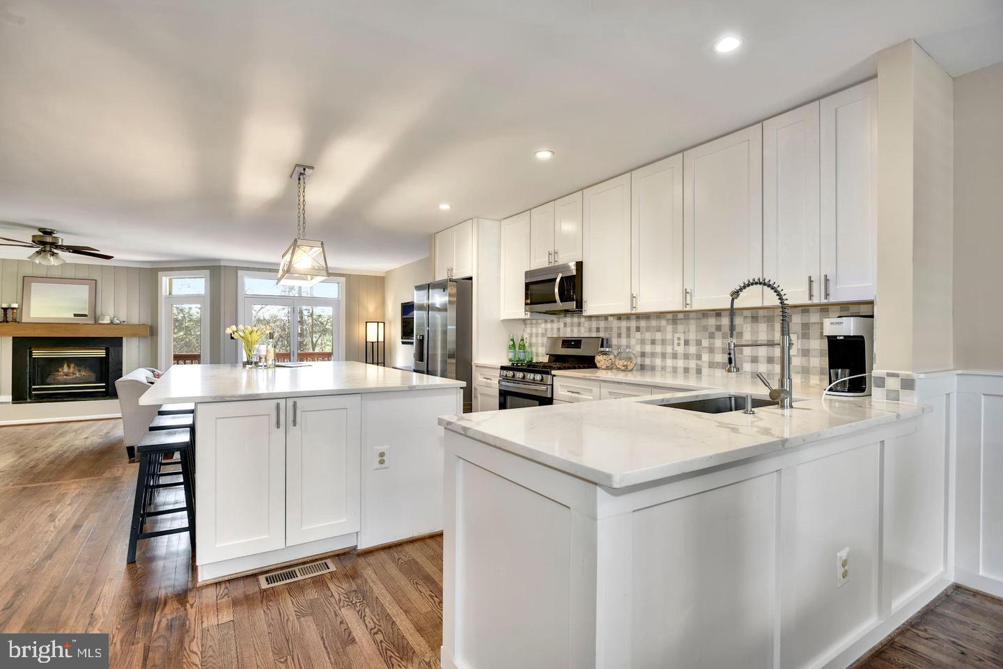 a kitchen with a sink cabinets and wooden floor