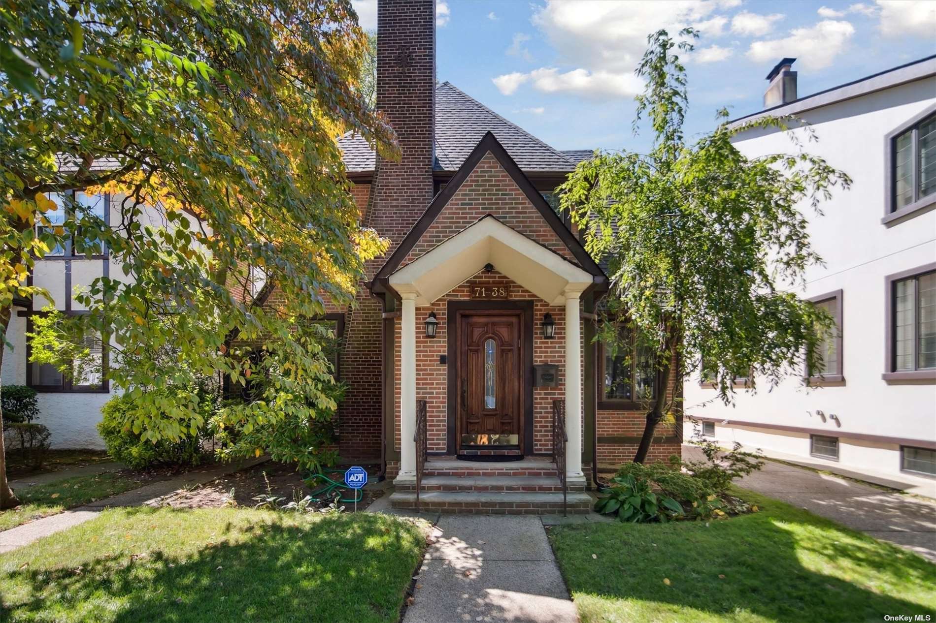 a front view of a house with garden