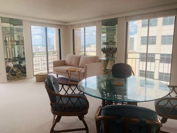 a living room with furniture and a floor to ceiling window