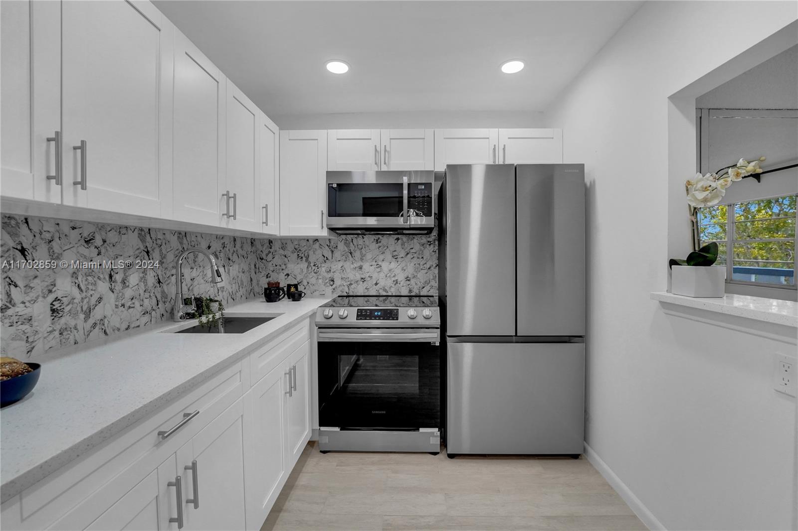 a kitchen with a sink and a refrigerator