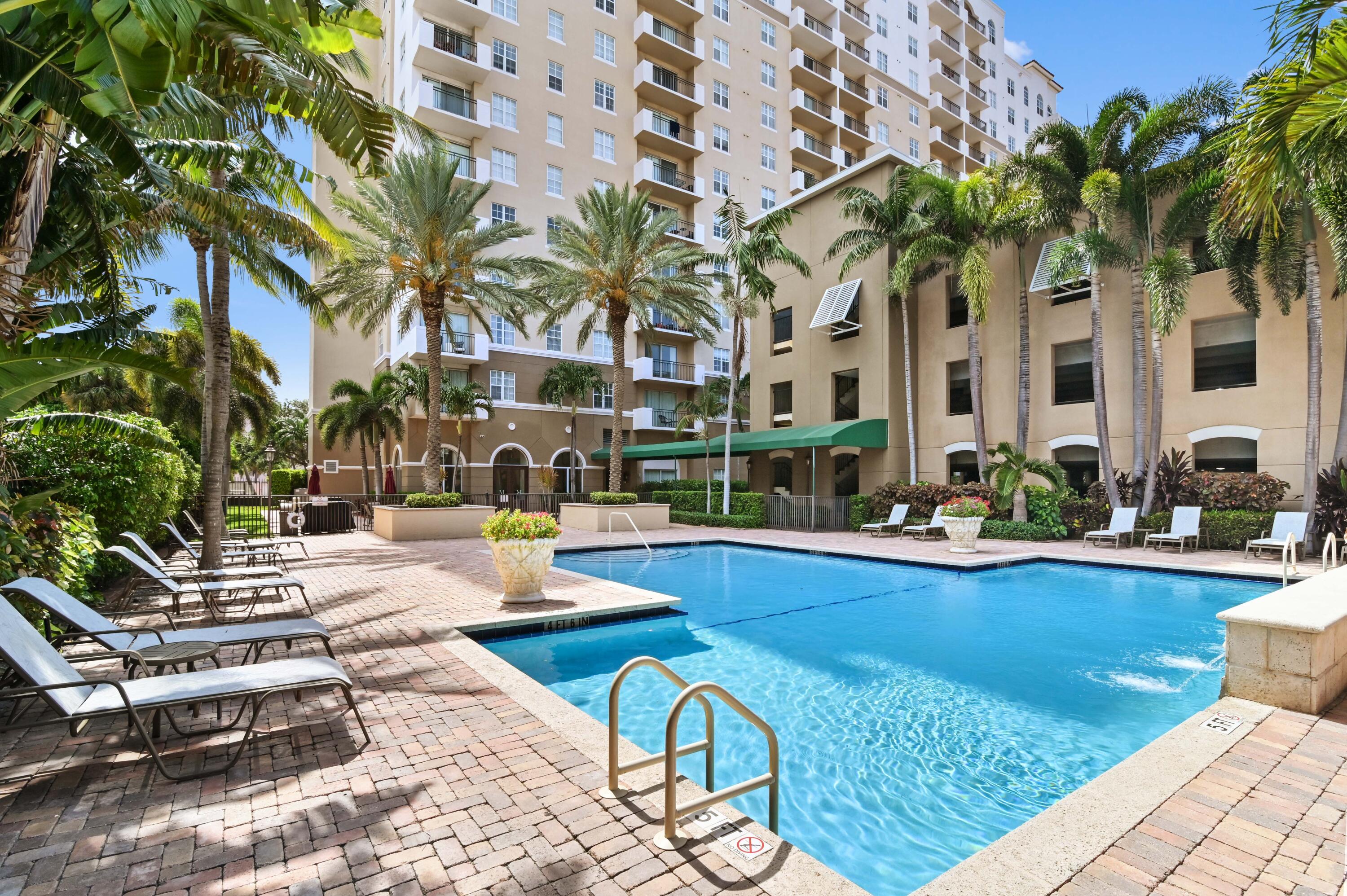 a view of swimming pool with outdoor seating and plants