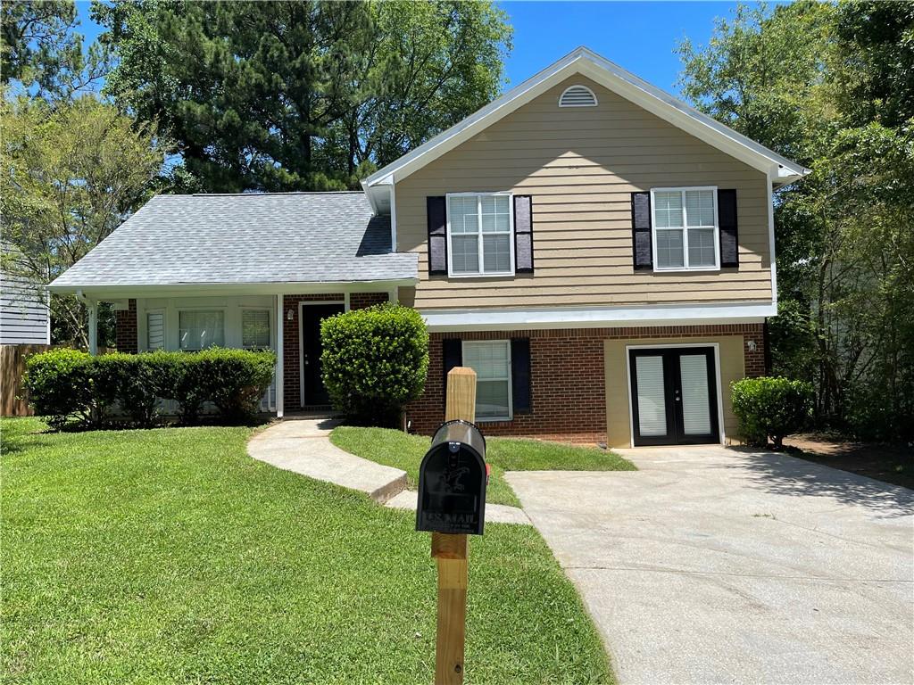 a front view of a house with a yard and garage