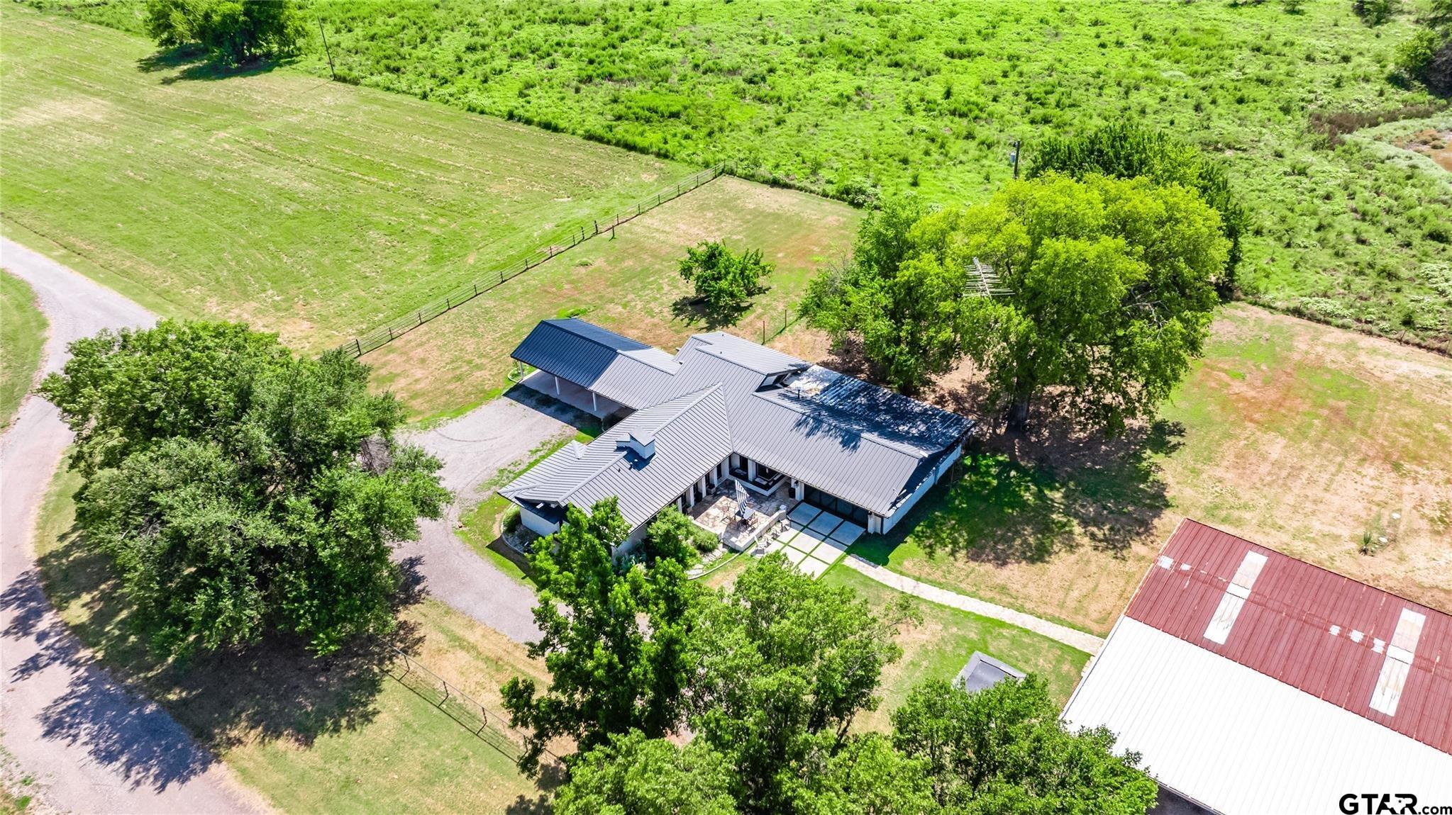 an aerial view of a house with garden space and street view