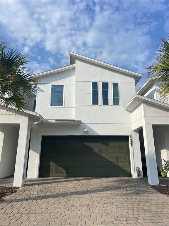 a front view of a house with garage