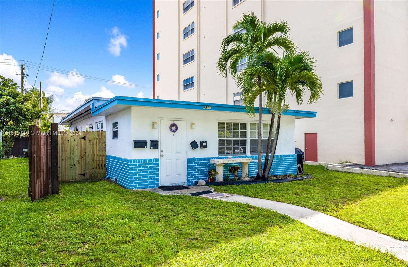 a view of a house with backyard and palm tree