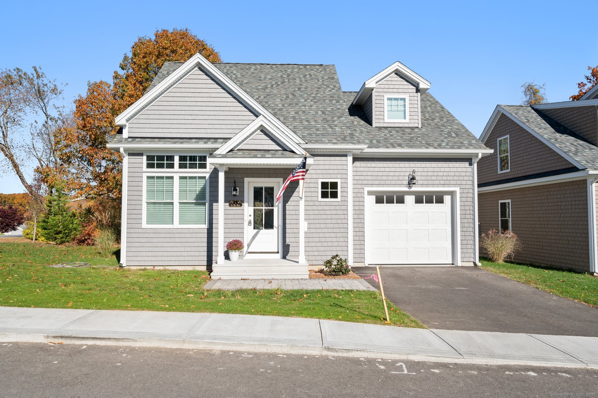 a front view of a house with a garden and plants