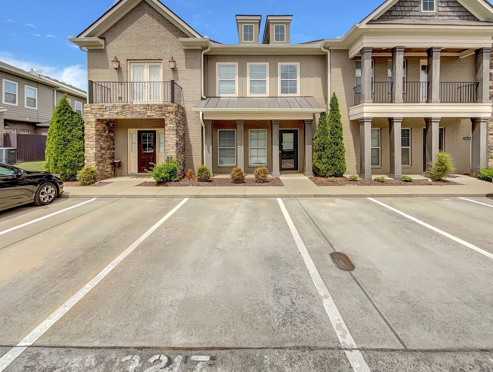 front view of a brick house with a yard