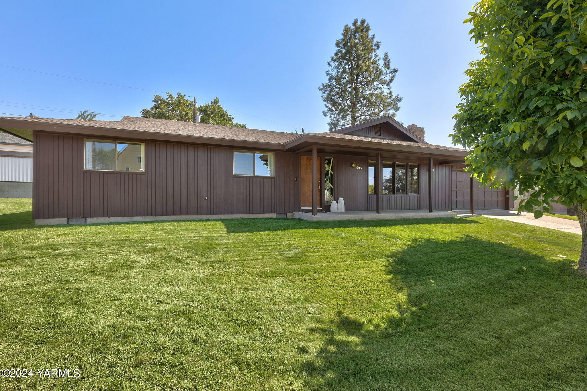 a front view of house with yard and outdoor seating