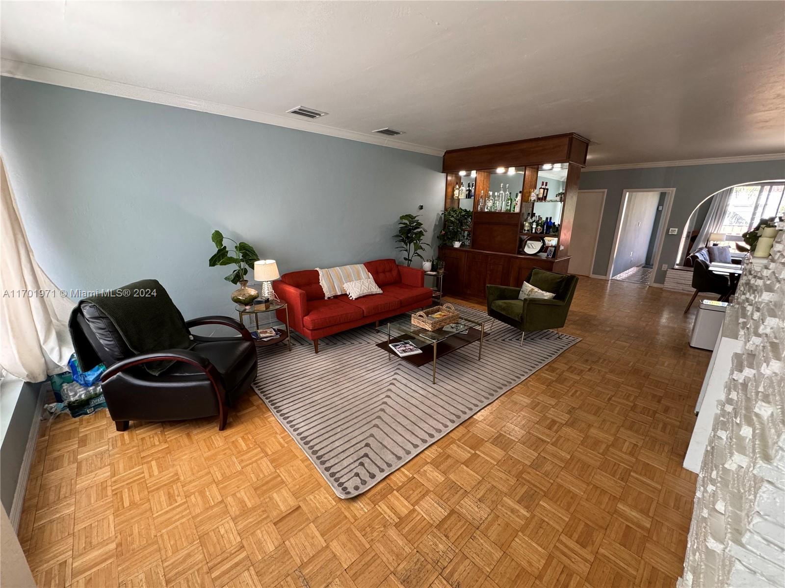 a living room with furniture rug and window