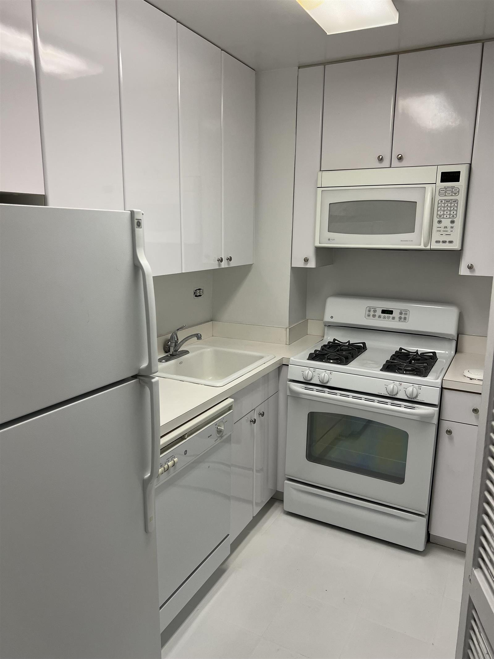 a utility room with cabinets washer and dryer